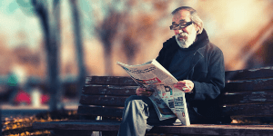 Elderly man reading his newspaper