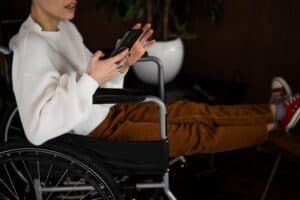 Woman in wheelchair on mobile phone