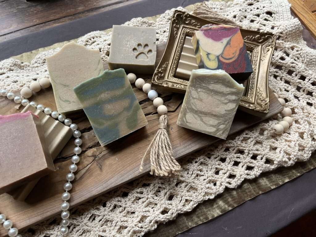 Flatlay of a variety of handcrafted goat's milk soaps made by Darcy